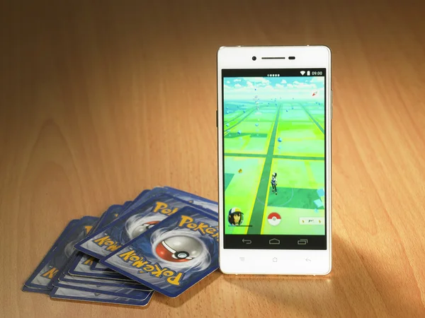 Smartphone and cards with pokemon go