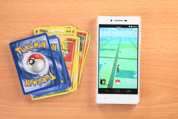 Smartphone and cards with pokemon go