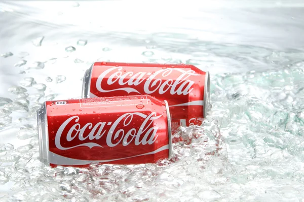 Coca cola cans with water splash