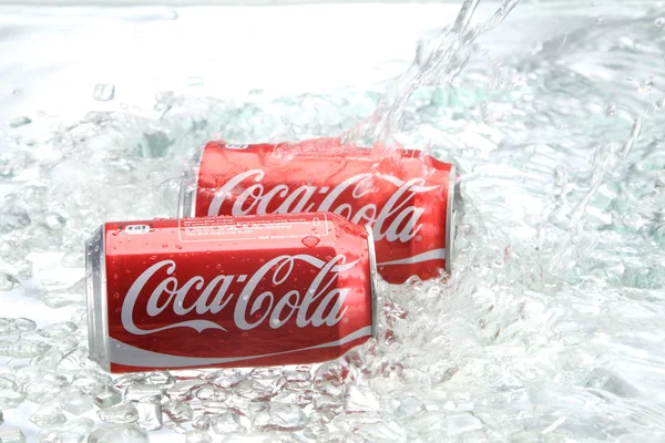 Coca cola cans with water splash