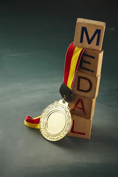 Golden medal with wooden blocks