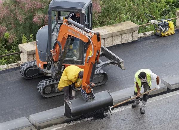 Italy, Sicily; 1 June 2016, men at work fixing a road - EDITORIAL