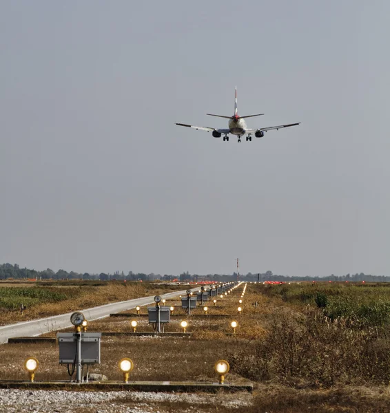 Italy, Venice International Airport; 14 September 2011, landing lights and an airplane landing - EDITORIAL