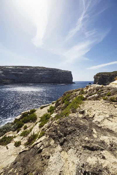 Malta Island, Gozo, view of sailing boats in the Dweira Lagoon and the rocky coastline near the Azure Window Rock