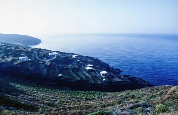 Italy, Sicily, Pantelleria Island (Trapani Province), view of the typical stone houses (dammusi) and the rocky volanic coastline of the island - FILM SCAN