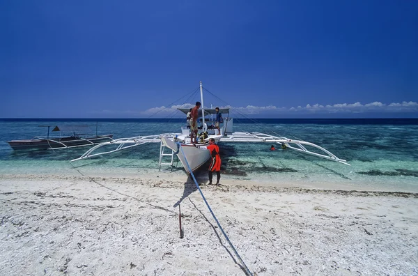 PHILIPPINES, Balicasag Island (Bohol); 20 March 2000, scuba divers and local wooden fishing boats ashore - EDITORIAL (FILM SCAN)