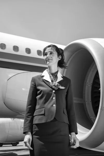 Stewardess near the airplane