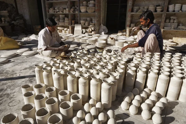 Men working in a ceramics factory