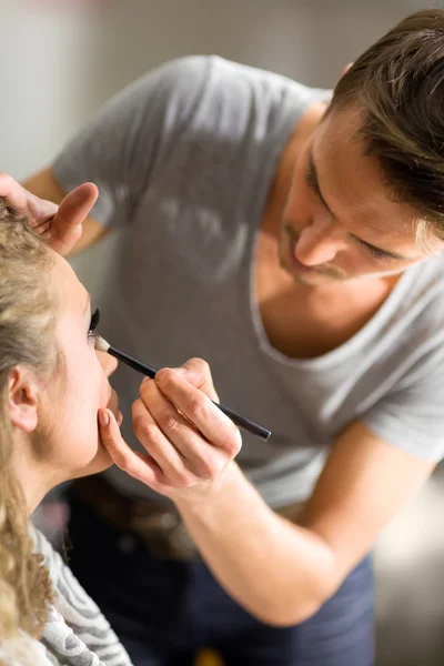 Professional Make-up artist doing model makeup at work