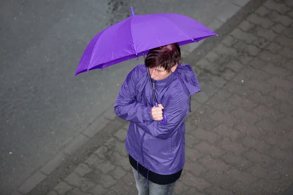 Raincoat dressed woman in the rain