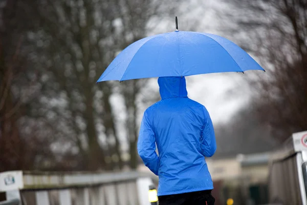 Rain walk with his umbrella and raincoat