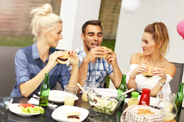 Group of friends eating hamburgers