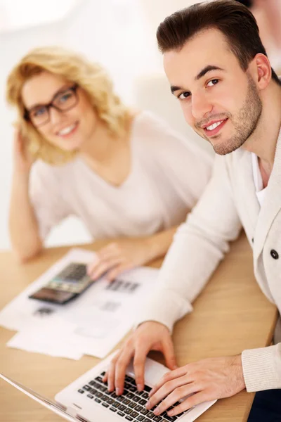 Young couple working on documents at home