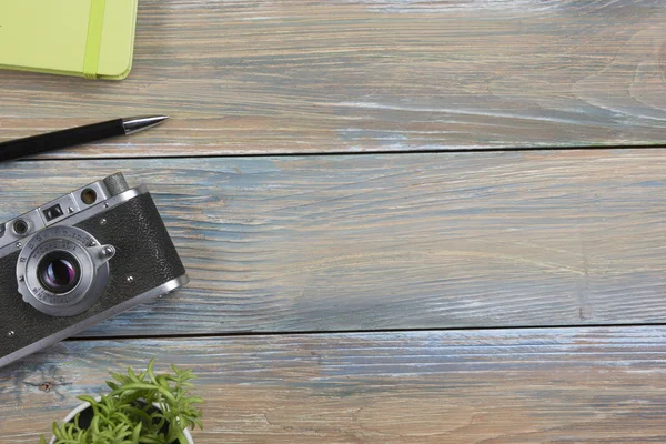 Tourism, travel concept. Office desk table with notepad, camera and supplies. Top view. Copy space for text.