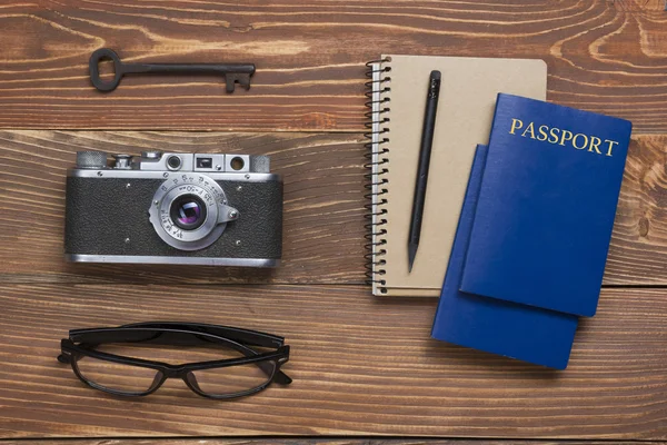 Travel, vacation concept. Camera and supplies on office wooden desk table. Top view with copy space for text