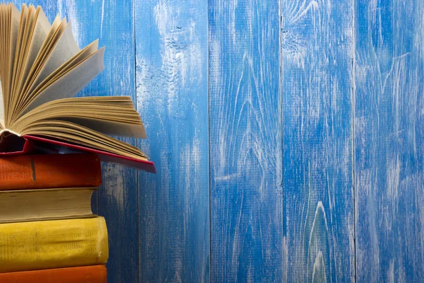 Open book, hardback books on wooden table. Back to school. Copy space for text