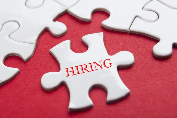 HIRING concept.  Missing Piece Jigsaw Puzzle with word