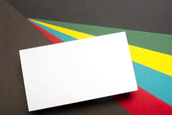 Business card blank over colorful abstract background. Corporate stationery branding mock-up