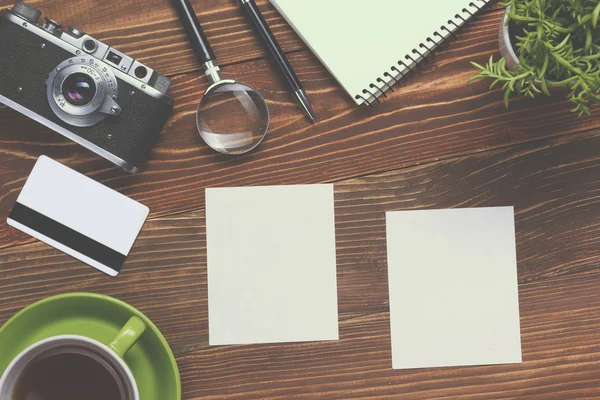 Travel, vacation concept. Camera, notepad, pen, credit card, supplies and photography on office wooden desk table. Top view with copy space for text