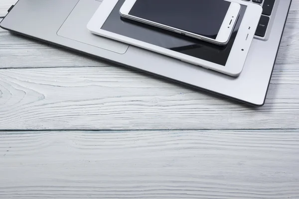 Set of modern computer devices - laptop, tablet and phone close up