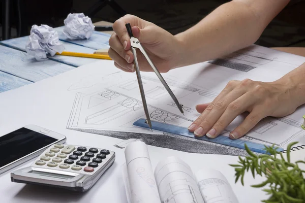 Architect working on blueprint. Architects workplace - architectural project, blueprints, ruler, calculator, laptop and divider compass. Construction concept. Engineering tools. Top view.