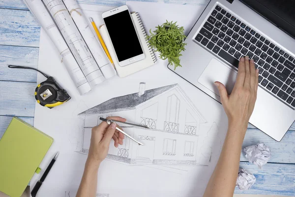 Architect working on blueprint. Architects workplace - architectural project, blueprints, ruler, calculator, laptop and divider compass. Construction concept. Engineering tools. Top view.