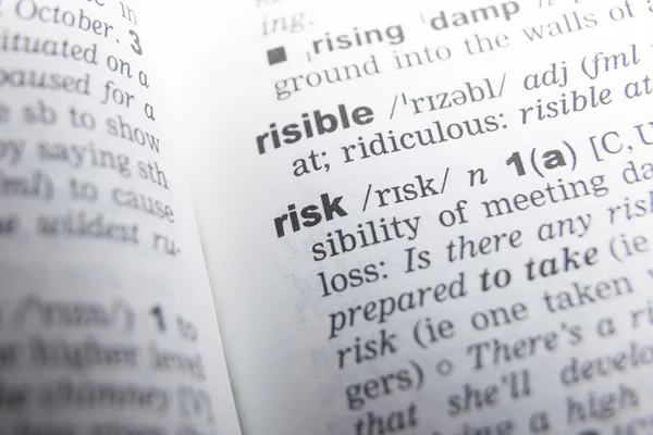 Close up of English dictionary page with word risk
