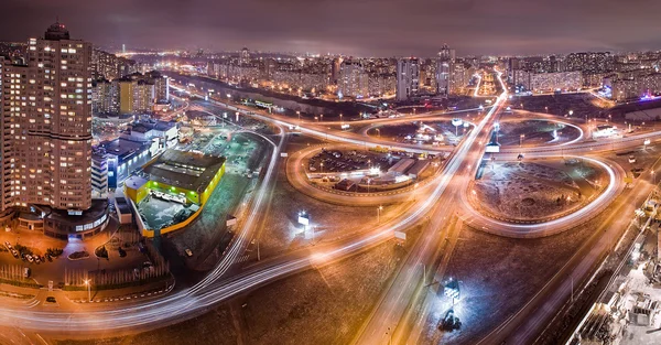 Highway at night in modern city. Aerial view of cityscape