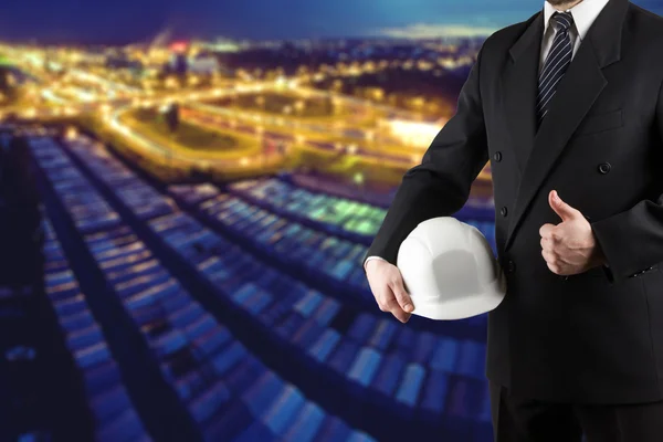 Close up of engineer hand holding white safety helmet for worker