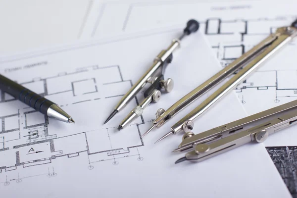 Architectural project, blueprints, blueprint rolls and divider compass, calipers on plans Engineering tools view from the top. Copy space. Construction background.