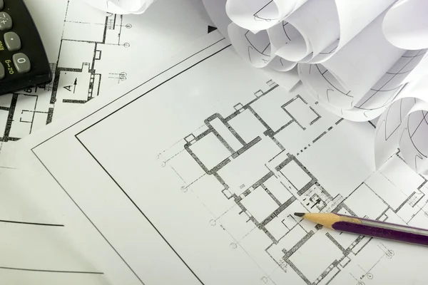 Architectural project, blueprints, blueprint rolls on plans. Engineering tools view from the top. Copy space. Construction background.