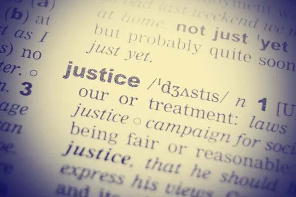 Dictionary definition of the word Justice in English. Vignetting effect.