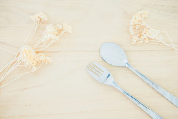 Fork and spoon on wood texture background