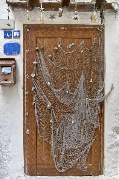 Fishing net used as decoration door of a house Sperlonga