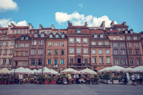 Old town marketplace square with colorful houses and outdoor cafes in Warsaw, Poland