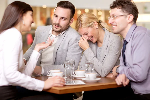 Group of business people  meeting in coffee shop and holding a b