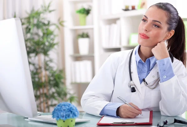 Young female doctor working in office