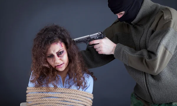 Terrorists threatening the a frightened girl with gun
