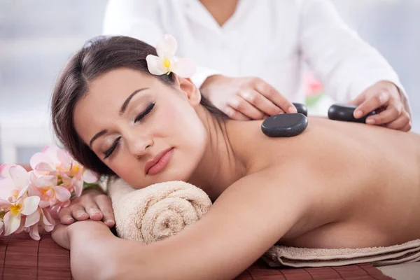 Beautiful woman having a wellness back massage at spa salon