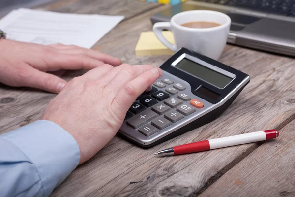 hands of businessman and calculator