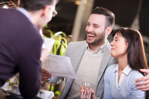 Smiling group of business people in coffee shop