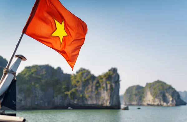 The flag of Vietnam on blue sky background in the Ha Long Bay