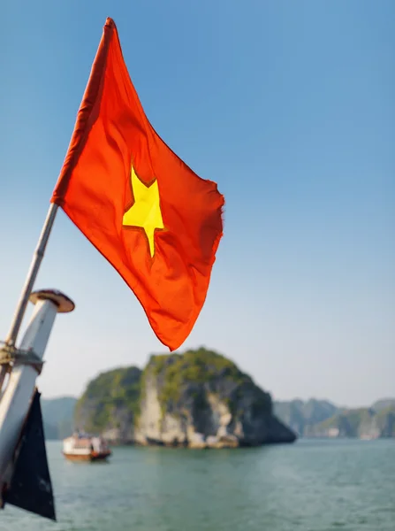 The flag of Vietnam fluttering on ship, the Ha Long Bay