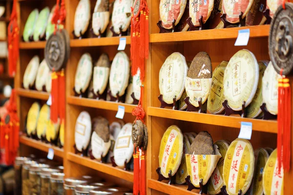 Disks of post-fermented tea Yunnan Puer on shop shelves, Lijiang