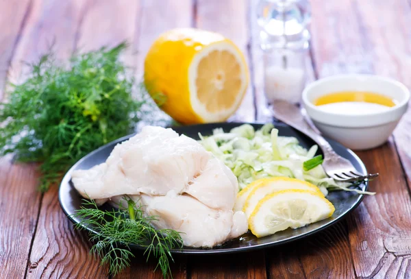 Boiled fish with lemon