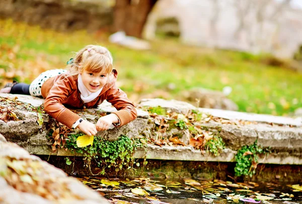 Girl playing in pond