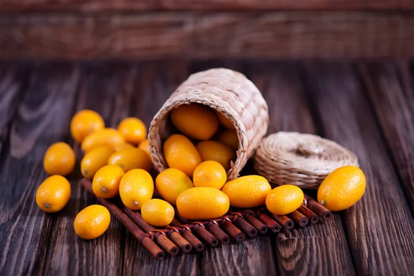 Fresh kumquats in wicker box