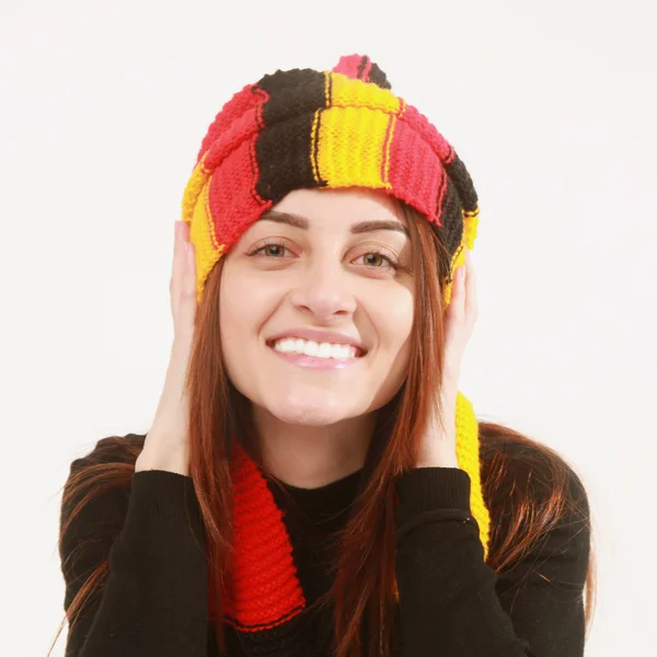 German soccer fan cheers football team in the national colors.