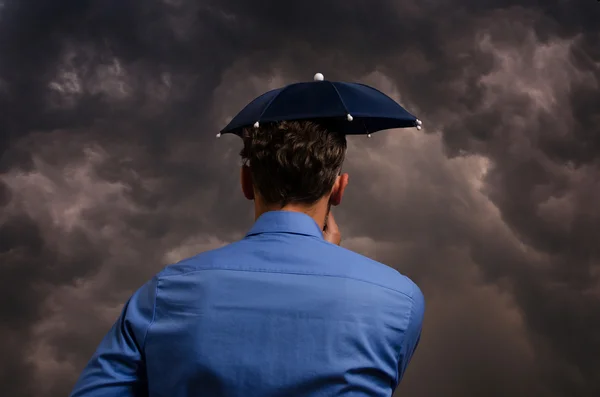 Business man with small umbrella