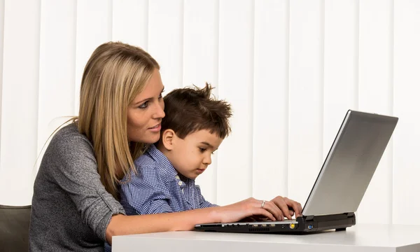 Mother and son at computer